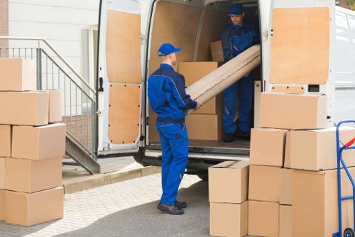 Man and van moving boxes in Archway residential street